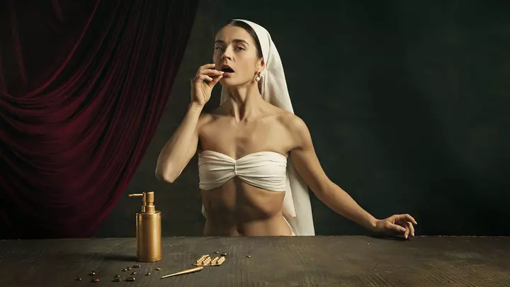 A woman taking an anti-aging supplement on a dark background, depicted as a classical artwork